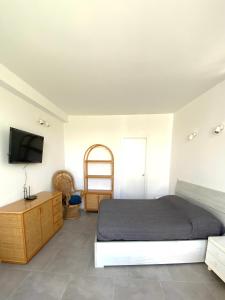 a bedroom with a bed and a flat screen tv at La Stella Marinella in Santa Marinella