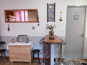 Zimmer mit Hockern, einem Tisch und einem Spiegel in der Unterkunft L'Astazou "PRÊT gracieux du matériel de SKI" au studio in Luz-Saint-Sauveur