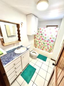 a bathroom with a sink and a toilet at Seabreeze Inn in West End