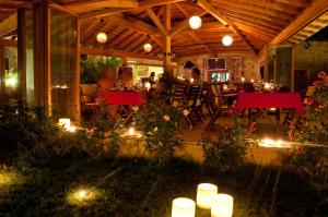 a patio with a table and chairs and lights at Lycia Hotel in Kaş
