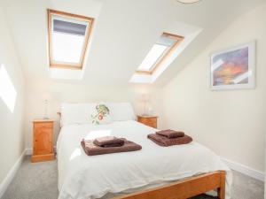 a bedroom with a bed with two towels on it at Stargazer - Uk43267 in Luppitt