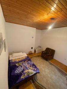 a bedroom with a bed and a couch in a room at Stolac Home River in Stolac