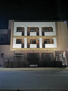 a building with two garages on the side of it at Hotel DaMar in Costinesti