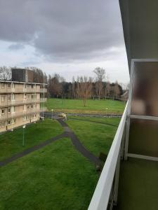 a view from a balcony of a building and a field at The Sweet Cocoon in De Haan