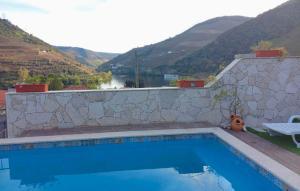a swimming pool with a view of a mountain at Casa Nunes in Pinhão