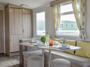 a dining room with a table and a couch at Seaview 1 in Heysham