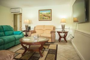 a living room with a couch and a table at Seawind Beach Apartments in Montego Bay