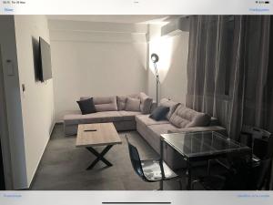 a living room with a couch and a table at Exclusive ladadika apartment 1 in Thessaloniki