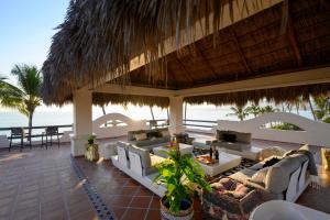 a resort patio with couches and a view of the ocean at Villa Cobojo in Bucerías