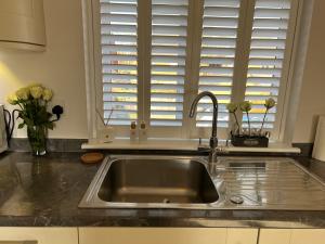 a kitchen counter with a sink and a window at Cathedral Coach House in Lichfield