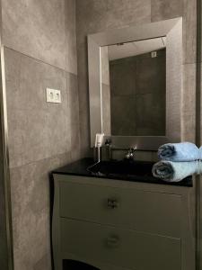 ein Badezimmer mit Waschbecken und Spiegel in der Unterkunft Penthouse Luxury Granada in Granada + 24 Fotos