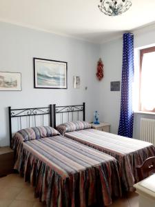 Postel nebo postele na pokoji v ubytování La Casa Più Sù