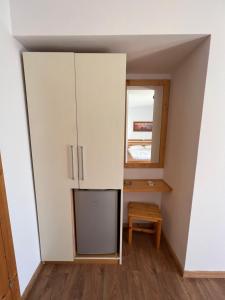 a small room with a cabinet and a mirror at Argileos in Himare