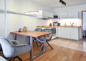 a kitchen and dining room with a wooden table and chairs at Ferienwohnung Alpenglück hoch3 in Oy-Mittelberg