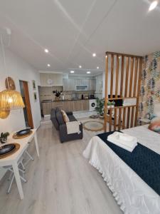 a bedroom with a bed and a living room at Lucas House in Nazaré