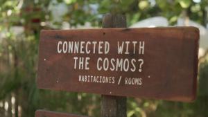 a sign that reads connected with the cosmos at Astral Tulum in Tulum