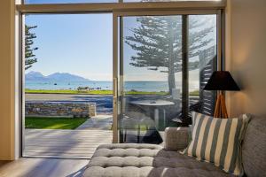 a living room with a couch and a view of the ocean at Shearwater Apartments in Kaikoura