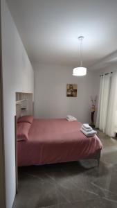 a bedroom with a red bed in a white room at Bruno's House in Pescara