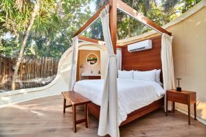 Voodi või voodid majutusasutuse Astral Tulum toas