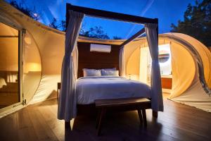Voodi või voodid majutusasutuse Astral Tulum toas