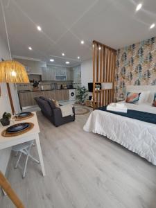 a bedroom with a bed and a living room at Lucas House in Nazaré