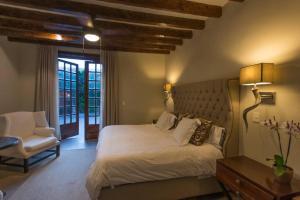 a bedroom with a bed and a chair and a window at AMAZING HOME WITH POOL IN A STELLAR LOCATION in San Miguel de Allende