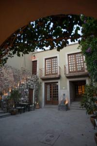 a building with a courtyard with tables and windows at AMAZING HOME WITH POOL IN A STELLAR LOCATION in San Miguel de Allende