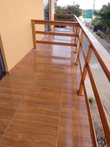a wooden porch with a wooden railing on a house at Chalé Aconchego da Serra in Serra de São Bento
