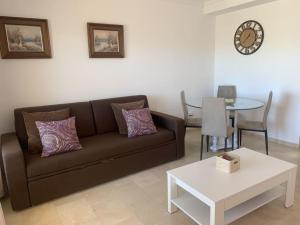 a living room with a couch and a table at Las Brisas de Puerto Rico in Mogán