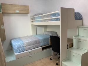 a bedroom with a bunk bed and a desk at Las Brisas de Puerto Rico in Mogán +20 photos