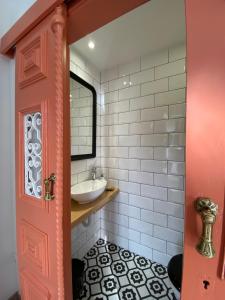 a bathroom with a sink and a mirror at Villa Tauria- Casa de campo em aldeia medieval in Sabugal +37 photos