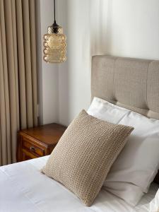 a bedroom with a bed with a pillow and a chandelier at Villa Tauria- Casa de campo em aldeia medieval in Sabugal