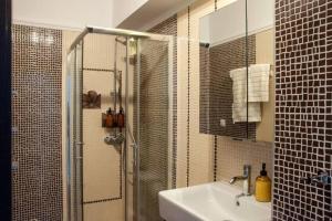 a bathroom with a shower with a sink and a shower at East Coast Senses in Thessaloniki