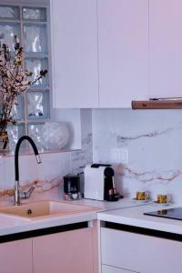 a white kitchen with a sink and a toaster at East Coast Senses in Thessaloniki