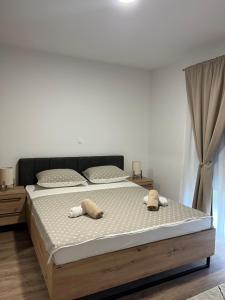 a bedroom with a bed with two towels on it at Apartment Lux Lucis in Livno