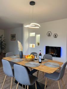 a dining room with a wooden table and chairs at Apartment Lux Lucis in Livno