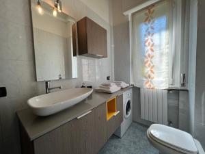 a bathroom with a sink and a washing machine at Relax Segrate in Segrate