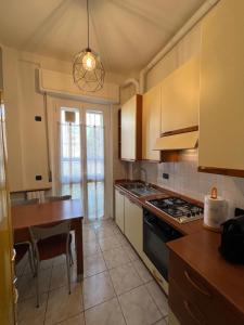 a kitchen with a table and a stove top oven at Relax Segrate in Segrate +27 photos