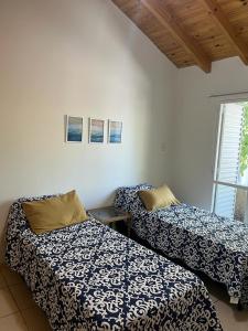 Habitación con 2 camas y sábanas azules y blancas. en Luminoso y amplio departamento en Mendoza