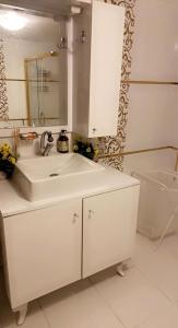 a white bathroom with a sink and a tub at Bursa Park in Çekirge