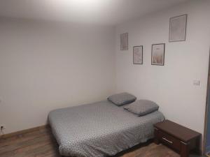 a small bedroom with a bed and a table at Petite maison lirenolles in Liernolles