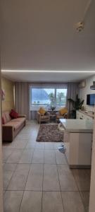 a living room with a couch and a table at Relax-Lugano Lake in Bissone
