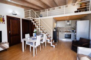 a dining room with a table and a staircase at Villa MiraMar Luxury Suite Palermo Airport in Carini
