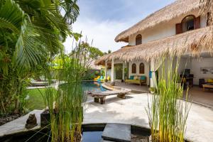 a villa with a swimming pool and a resort at Elina Villas in Seminyak