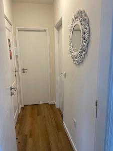 a hallway with a mirror and a white door at RETIRO 401 one-bedroom apartment in Guimarães
