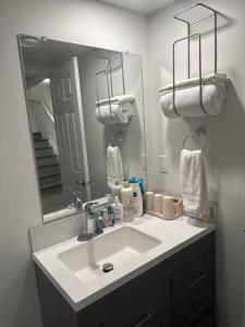 W łazience znajduje się umywalka i lustro. w obiekcie Brand new 1 Bedroom Basement Suite. Wi-Fi,Netflix w mieście Edmonton