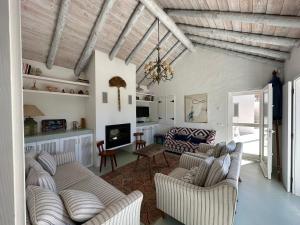 a living room with two couches and a tv at Casas na Lagoa - Carvalhal in Carvalhal