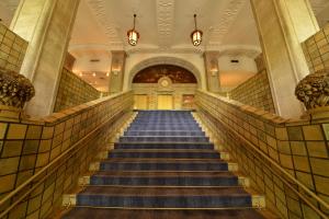 a stairway leading up to a large room at Hotel New Grand in Yokohama