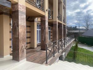 a balcony of a building with a wooden deck at RIVER SIDE in Polyana
