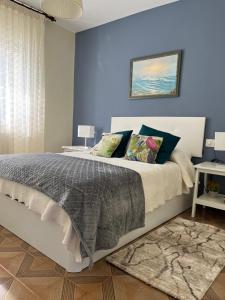 um quarto com uma cama com uma parede azul em Fogar de Aurora em Portomarín